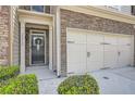 Inviting entryway with stone accents, neutral siding, and an attached two-car garage, creating a welcoming curb appeal at 2212 Knoxhill Se Vw, Smyrna, GA 30082
