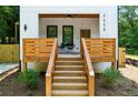 Inviting front porch featuring a ceiling fan, modern railings, a stylish entrance, and steps leading to a welcoming entrance at 2438 2Nd Nw St, Atlanta, GA 30318