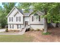 Attractive home with light siding, a tidy front yard, and a welcoming staircase leading to the front door at 324 Madeline Way, Temple, GA 30179