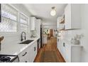 Modern white kitchen with stainless steel appliances, subway tile backsplash, and hardwood floors at 403 Blake Se Ave, Atlanta, GA 30316
