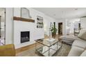 Bright living room featuring a decorative fireplace, hardwood floors, and an open layout at 403 Blake Se Ave, Atlanta, GA 30316