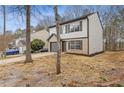 Charming two-story home with attached garage, and natural landscaping at 7074 Ravenwood Ln, Lithonia, GA 30038