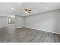 Open-concept living room with recessed lighting and luxury vinyl plank flooring at 7074 Ravenwood Ln, Lithonia, GA 30038