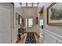 Bright foyer featuring hardwood floors, high ceilings, elegant wainscoting, and decorative accents at 4485 Cadmium Dr, Cumming, GA 30040