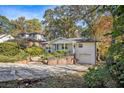 Charming brick home with a well-manicured lawn, inviting entrance, and attached garage at 490 E Pharr Rd, Decatur, GA 30030