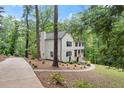 Charming two-story home with painted brick foundation, lush landscaping and winding driveway at 800 Breckinridge Sw Rd, Marietta, GA 30064