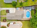Aerial view of a home with a large backyard featuring a pool, hot tub, lounge chairs, and green grass at 1928 Main Nw St, Atlanta, GA 30318