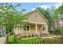 Quaint home with a covered front porch, inviting curb appeal, and a picket fence surrounding the property at 557 Lawton Sw St, Atlanta, GA 30310