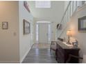 Bright foyer showcasing wood floors, white stairs, a high ceiling, and a lovely front door at 690 Winding River Dr, Lawrenceville, GA 30046