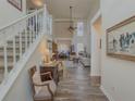 Open-concept foyer with high ceilings, wood floors, staircase, and views into the living room at 690 Winding River Dr, Lawrenceville, GA 30046
