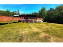 View of backyard featuring a wooden deck and expansive lawn at 105 Doe Dr, Temple, GA 30179