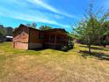 Exterior view of home featuring wood siding and a spacious yard at 105 Doe Dr, Temple, GA 30179