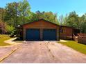 Two-car garage with blue doors and driveway at 105 Doe Dr, Temple, GA 30179