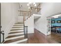 Grand foyer with high ceilings, hardwood floors, and staircase with iron spindles at 1880 Redbourne Dr, Atlanta, GA 30350