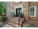 Elegant double front door with decorative glass, sidelights, and brick steps with iron railing at 1880 Redbourne Dr, Atlanta, GA 30350