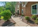 Beautiful brick home featuring a walkway with attractive landscaping at 1880 Redbourne Dr, Atlanta, GA 30350
