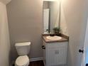 Cozy bathroom featuring a vanity with a granite countertop and a decorative mirror at 241 Coral Cir, Mcdonough, GA 30253