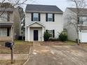 Inviting home featuring a well-maintained lawn and a private walkway to the front door at 241 Coral Cir, Mcdonough, GA 30253
