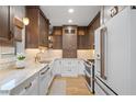 Modern kitchen featuring a white refrigerator, stainless steel appliances, and granite countertops at 28 Peachtree Hills Ne Ave, Atlanta, GA 30305