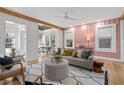 Cozy living room featuring hardwood floors, pink walls and lots of natural light at 28 Peachtree Hills Ne Ave, Atlanta, GA 30305
