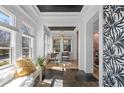 Bright sunroom with slate flooring, black ceiling, and lots of natural light at 28 Peachtree Hills Ne Ave, Atlanta, GA 30305