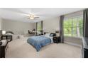 Spacious main bedroom with large windows, a ceiling fan, and room for a desk and seating at 4934 Woodstream Nw Ln, Acworth, GA 30102