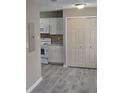 A view of the kitchen and flooring, including white cabinets, counters and appliances at 6354 Shannon Pkwy # 20D, Union City, GA 30291