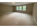 Unfinished bedroom with three large windows and neutral paint awaiting personalization at 6861 Ga Hwy 5, Douglasville, GA 30135