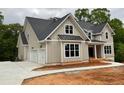 New construction home featuring a three-car garage and neutral-toned exterior with white trim at 6861 Ga Hwy 5, Douglasville, GA 30135