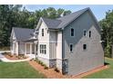 Gray home with large windows and stone accents along the base with lush green lawn at 6861 Ga Hwy 5, Douglasville, GA 30135