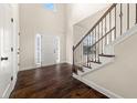 Bright foyer with dark hardwood floors and a staircase, leading to the upper level at 3257 Alhambra Cir, Hampton, GA 30228
