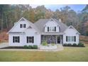 Beautiful single-Gathering home boasting a manicured lawn, stone accents, and a welcoming covered porch at 401 Night Hawk Ct, Canton, GA 30114