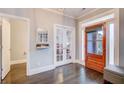 A view of the home's foyer with gleaming wood floors and a glimpse into other rooms at 401 Night Hawk Ct, Canton, GA 30114
