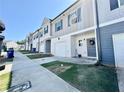 A row of townhomes featuring garages, welcoming front doors and manicured front lawns at 4940 Elm Brook Dr, Atlanta, GA 30349