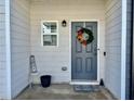 Cozy porch with a decorated gray door and a small 'HOME' sign adding a personal touch at 4940 Elm Brook Dr, Atlanta, GA 30349
