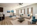 Bright living room featuring neutral furniture, modern ceiling fan, and an adjacent dining area for a seamless flow at 4940 Elm Brook Dr, Atlanta, GA 30349