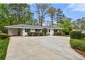 Ranch home featuring large driveway, white paint, and manicured shrubs at 1155 Moores Mill Nw Rd, Atlanta, GA 30327
