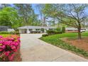 Well-kept ranch home featuring a driveway, vibrant azaleas, and meticulous landscaping at 1155 Moores Mill Nw Rd, Atlanta, GA 30327