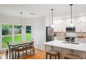 Bright kitchen boasts modern appliances, an island, and an adjacent breakfast area with backyard views at 1187 Druid Walk, Decatur, GA 30033
