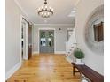 Entryway featuring wood floors, modern light fixture, and barn doors at 230 Pebble Trl, Alpharetta, GA 30009