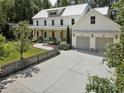 A modern farmhouse featuring a two-car garage and grey picket fence at 230 Pebble Trl, Alpharetta, GA 30009