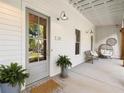 Inviting front porch with seating area and decorative plants at 230 Pebble Trl, Alpharetta, GA 30009