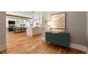 Hallway showcases hardwood floors and opens to a kitchen and dining area, blending seamless transition and style at 230 Pebble Trl, Alpharetta, GA 30009