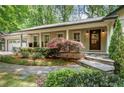 Inviting home exterior with stone steps and manicured landscaping at 5155 Pine Branch Pt, Atlanta, GA 30338