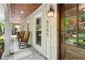 Welcoming front porch with rocking chairs and stone flooring at 5155 Pine Branch Pt, Atlanta, GA 30338