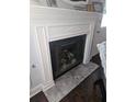 Close-up of a fireplace with a white mantle and tiled hearth, adding warmth to the home at 6620 Wellington Sq, Norcross, GA 30093