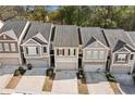 Expansive view of townhomes showing rooflines and parking at 3016 Creekside Overlook Way, Austell, GA 30168
