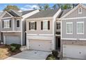 Charming townhome featuring a two-car garage and classic shutters at 3016 Creekside Overlook Way, Austell, GA 30168