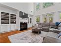 Bright living room boasts a fireplace, built-in shelves, large windows, and a comfortable sectional at 2265 Venture Dr, Marietta, GA 30062