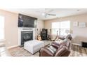 Cozy living room featuring a fireplace, ceiling fan, and comfortable leather seating at 314 Meadows Ln, Canton, GA 30114